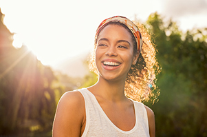 A woman smiling after flouride treatment at Encinitas Periodontics & Dental Implants in Encinitas, CA