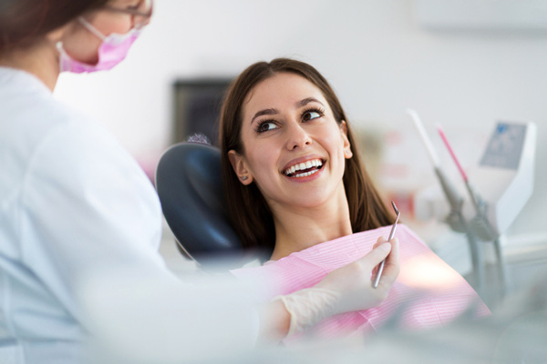 Woman in Encinitas, CA smiling in a dental chair at Encinitas Periodontics & Dental Implants